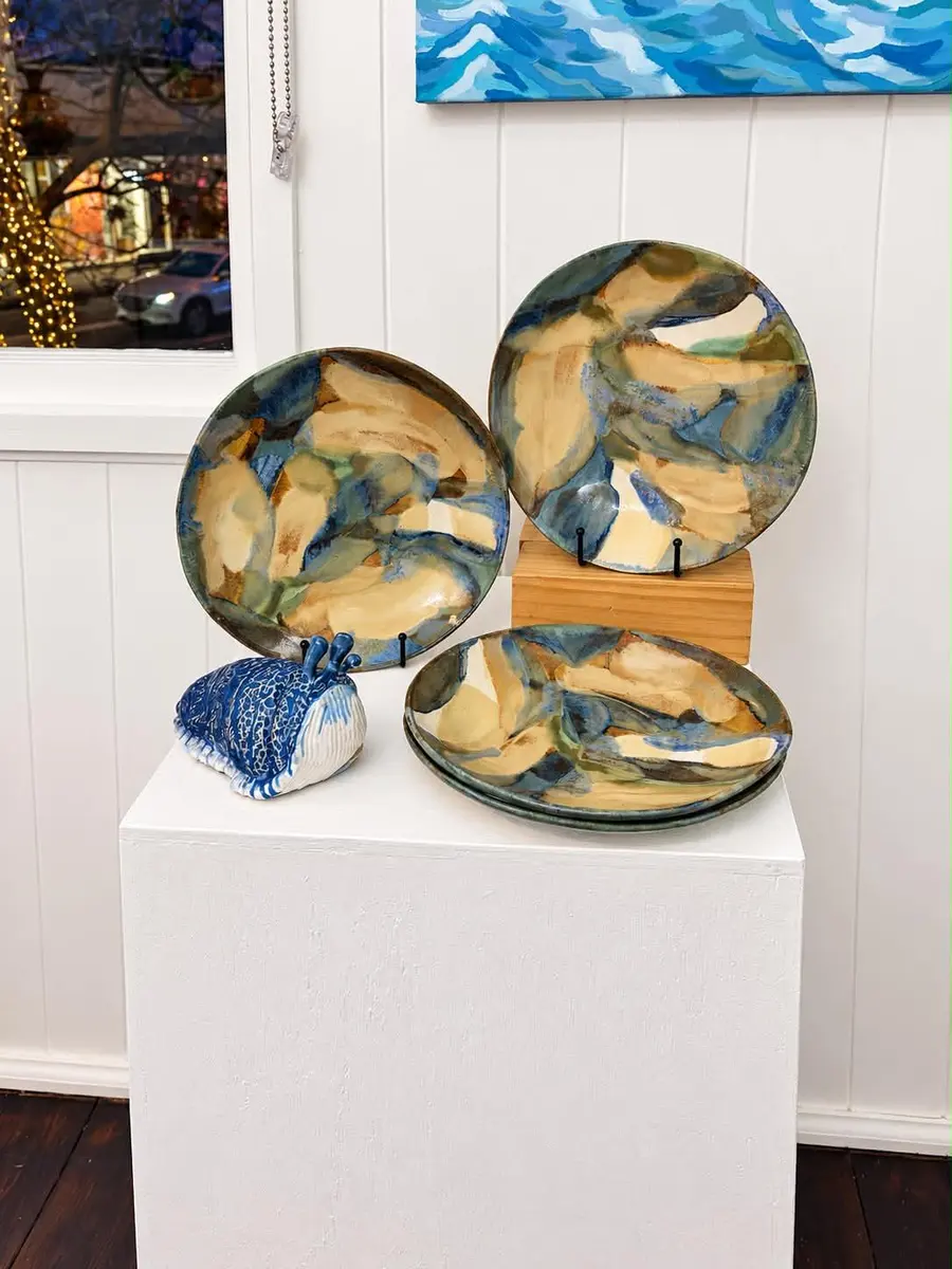 Glazed ceramic platters on a white plinth
