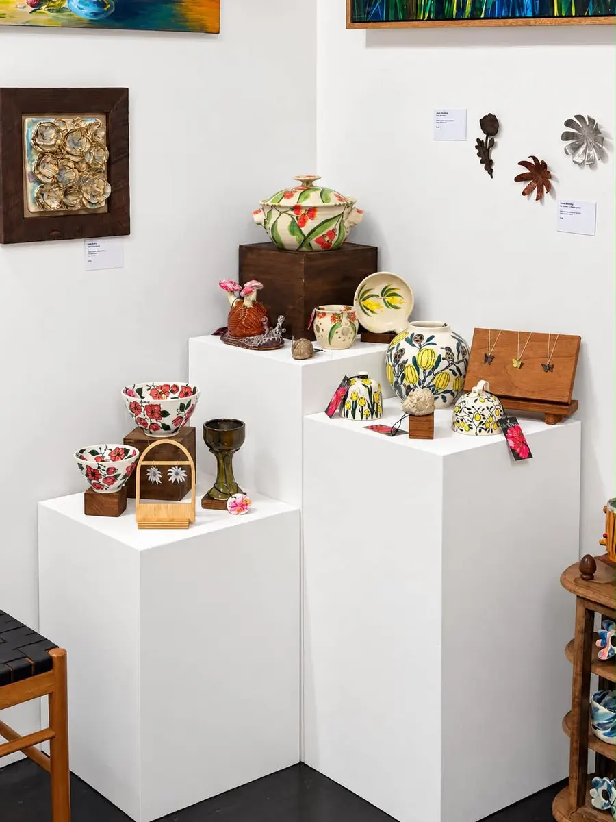 Ceramic pieces on stepped plinths in a gallery corner