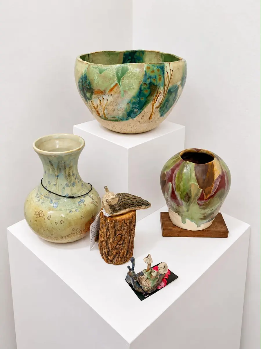 Glazed bowls and vases on white plinths