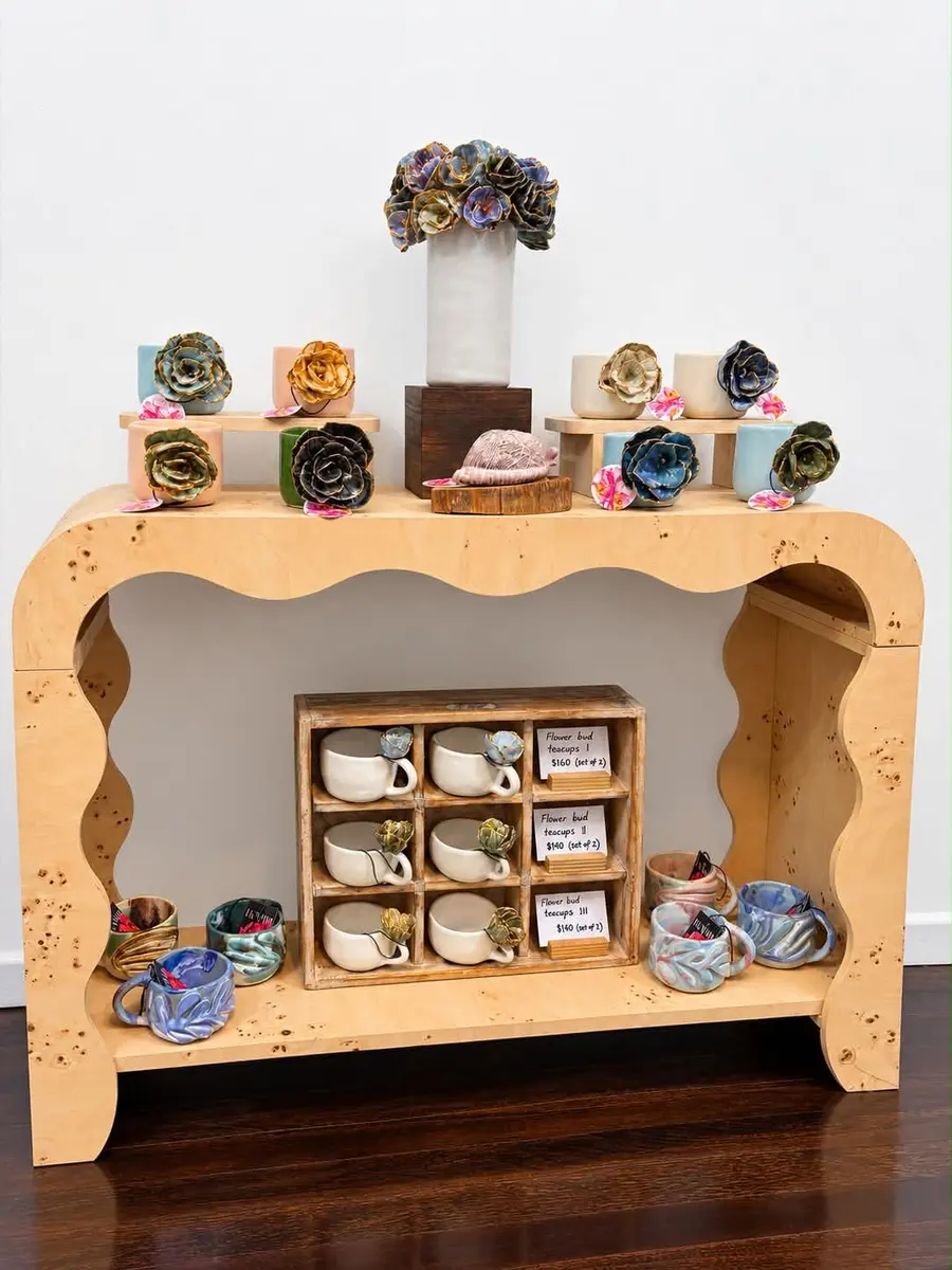 Cups and ceramics displayed on a curved timber console