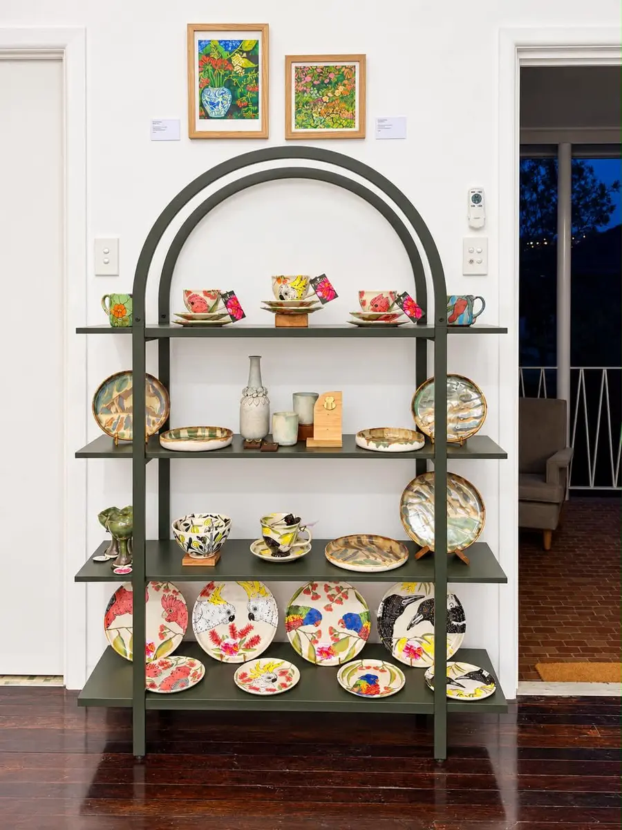 Painted plates and bowls on a metal shelving unit